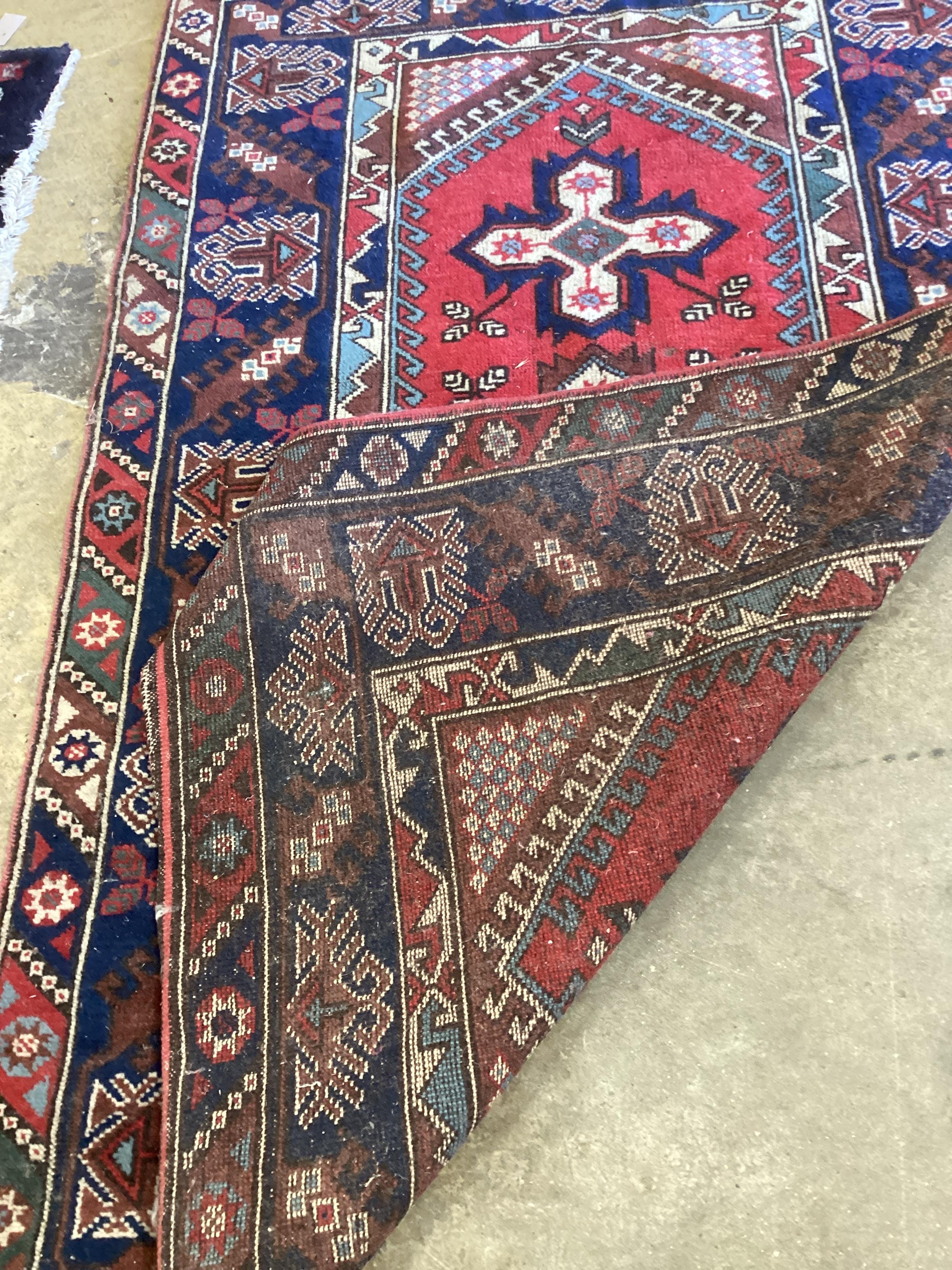 A Caucasian style red ground rug, 186 x 120cm